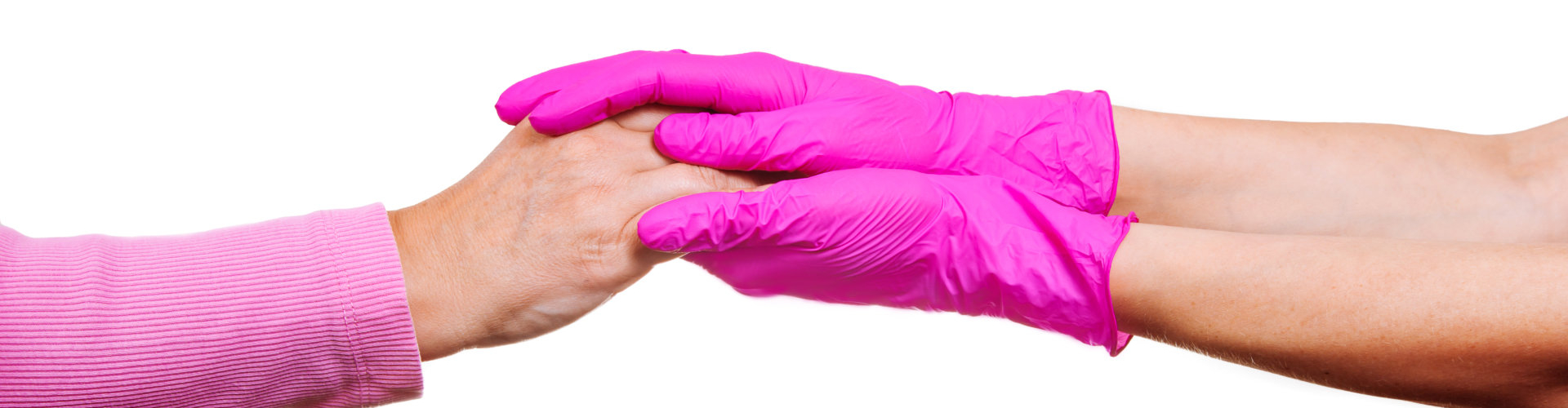 Female hands of a nurse or doctor in pink medical gloves hold hands of an old woman