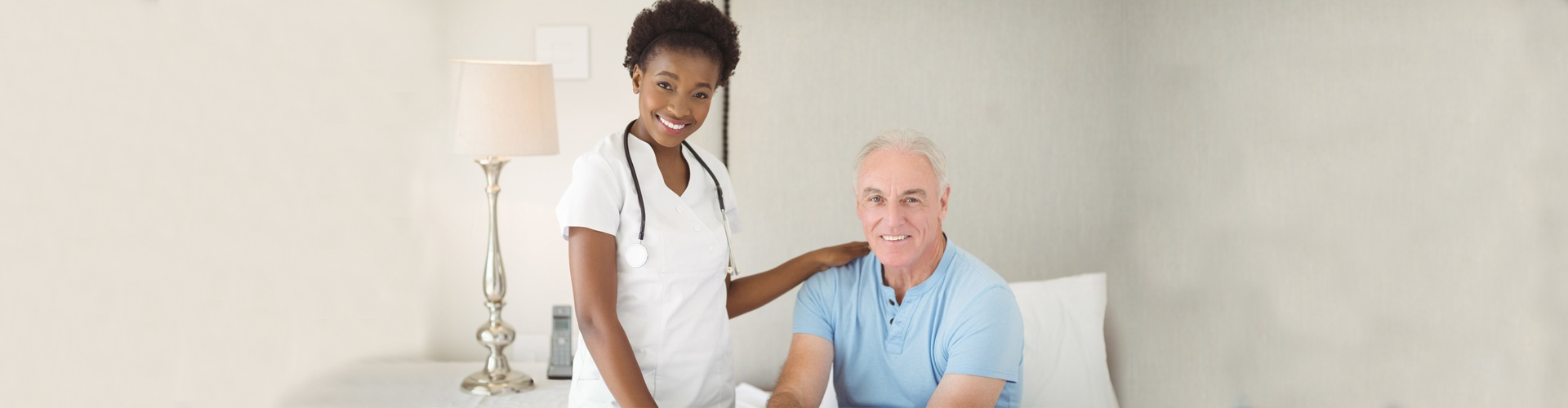 a caregiver and a senior man smiling